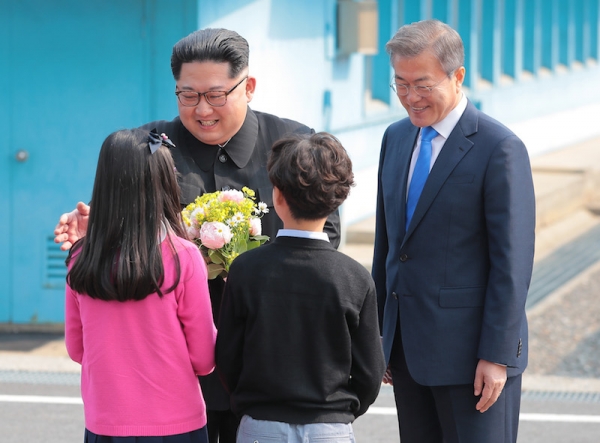 4月27日、板門店の軍事境界線上で握手する韓国の文在寅大統領と北朝鮮の金正恩国務委員長。写真は板門店合同取材団。